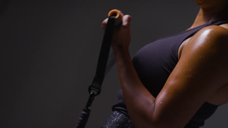 Close-Up-Studio-Shot-Of-Mature-Woman-Wearing-Gym-Fitness-Clothing-Exercising-With-Resistance-Band